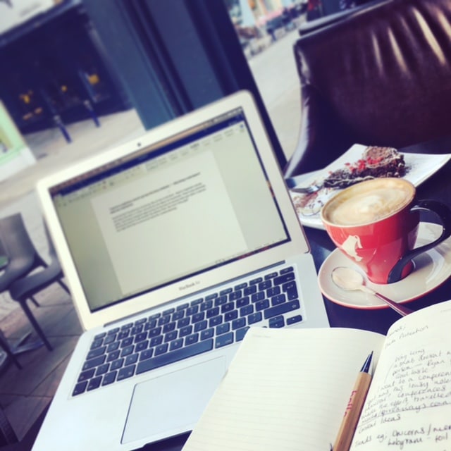 Notebook and coffee stay focused in cafes